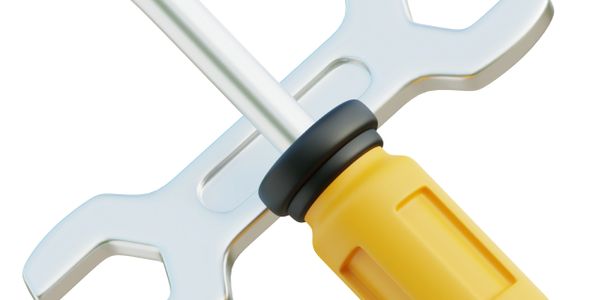 A wrench and a screwdriver crossed on a white background.