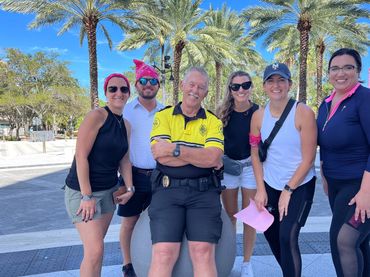A scavenger hunt team posing with a security guard