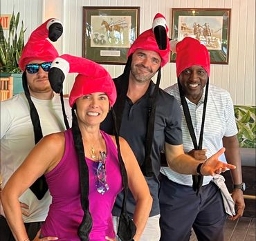 A scavenger hunt group wearing pink flamingo hats