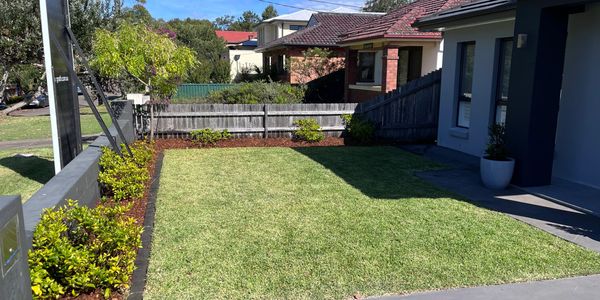 Lawn care pre-sale. Hedges trimmed, new mulch on the garden bed, lawn cut low and straight edges. 