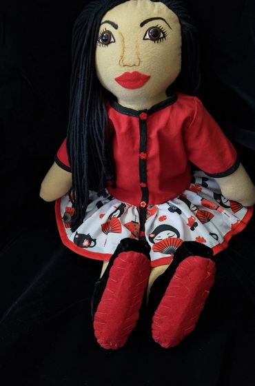 Asian doll in red Asian themed dress.