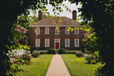 Two-story brick colonial home with covered front porch, Michigan style