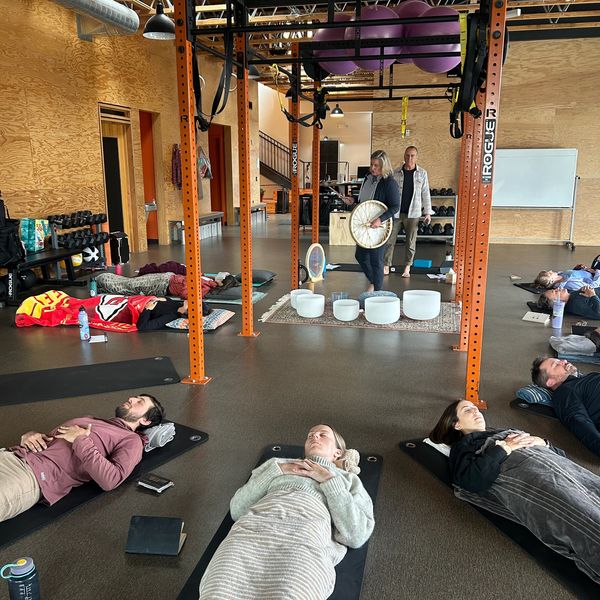 Group yoga or meditation session in gym-like studio.