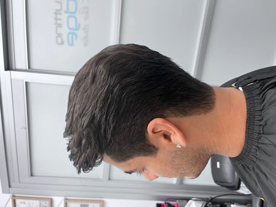 Side view of a fresh men's haircut with clean edges and volume.