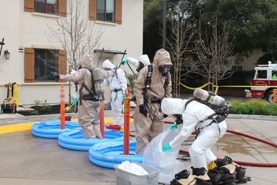 Firefighters are decontaminated.