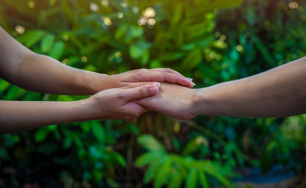 Man hand as lending a helping hand as trust together with compassion