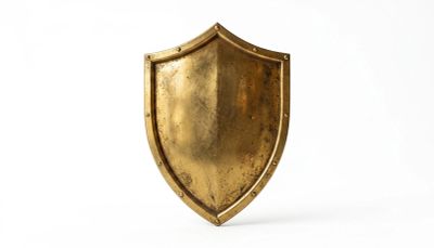 Antique brass shield on white background.