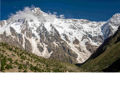 Snow-capped mountain peak under a bright blue sky.