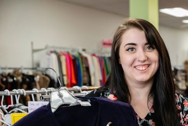 Woman holding the blue colored sweater