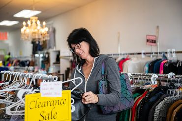 Woman checking the dresses in the clearance sale