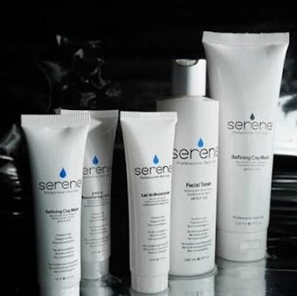 Serene skincare products lineup on a reflective surface.