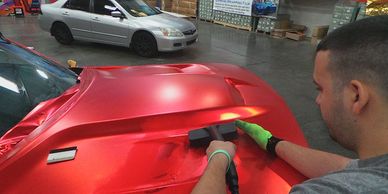 a man waxing a car in a garage
