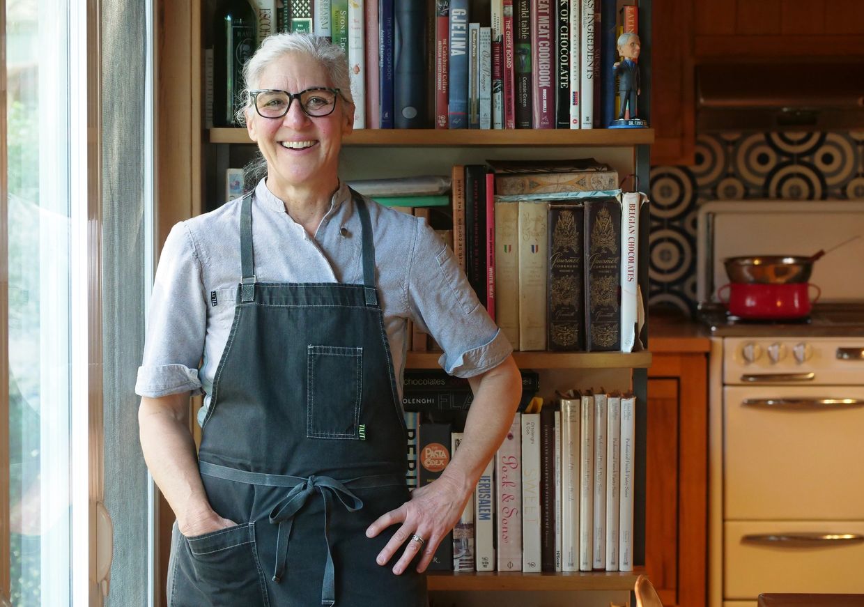Kara Caputo, Anchor Chocolates founder and chocolatier, in front of the books that inspire her.