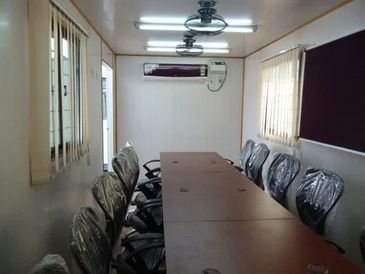 Conference room with chairs and a long table.