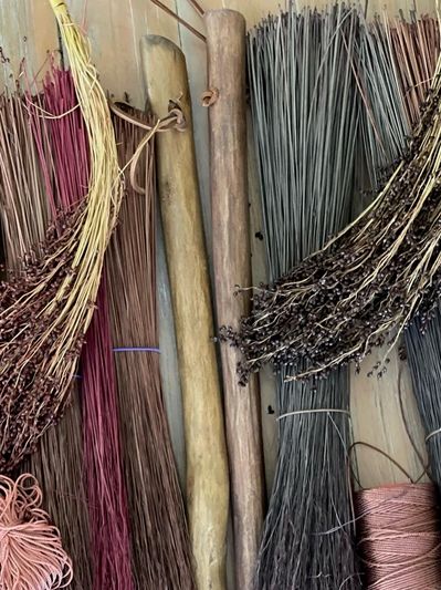 Bundles of colorful dried plants and wooden sticks.