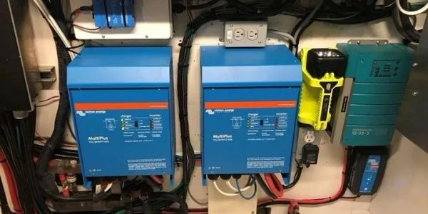 Electrical control panel with blue inverters and wiring.