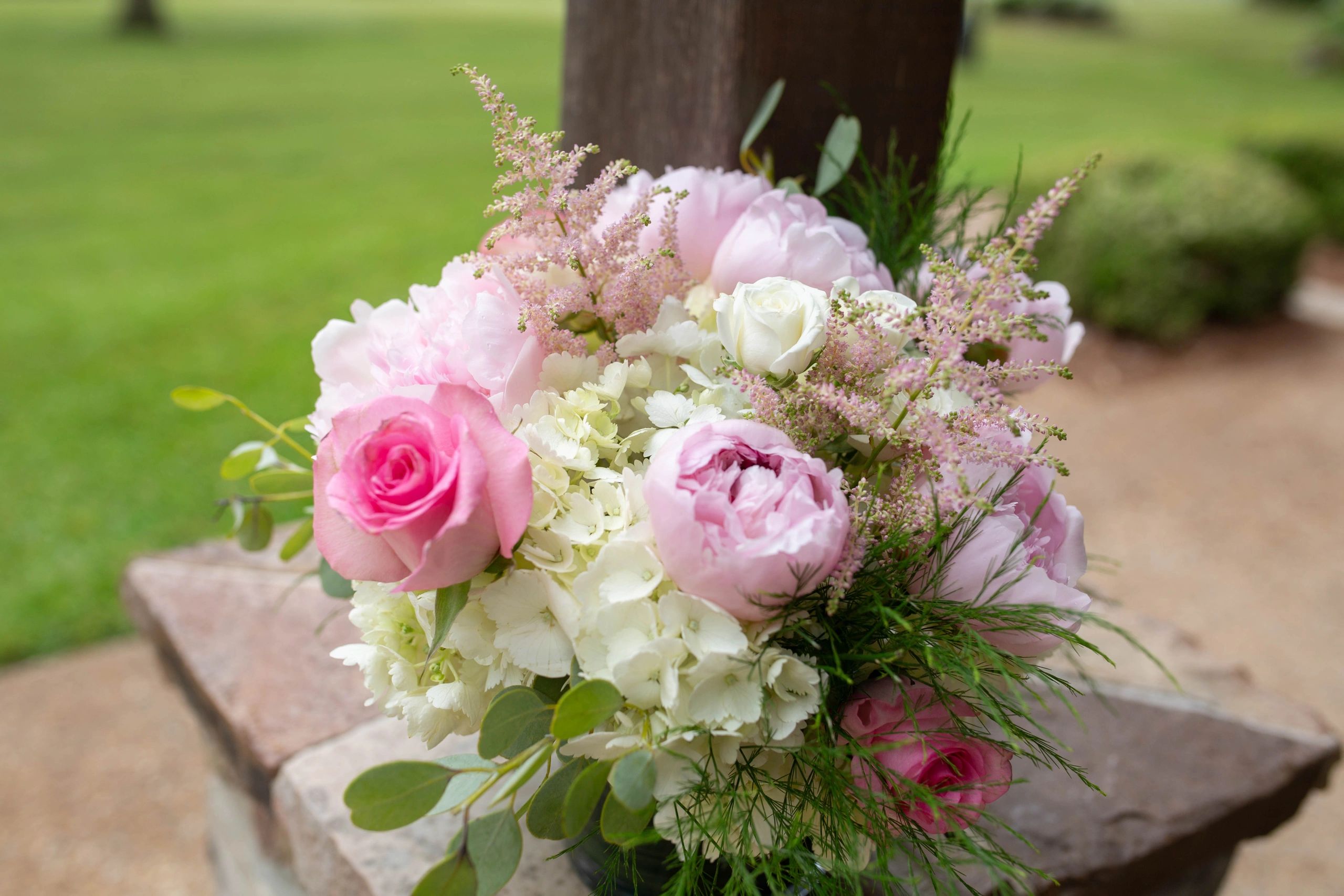 A bouquet of pink and white flowers with greenery.