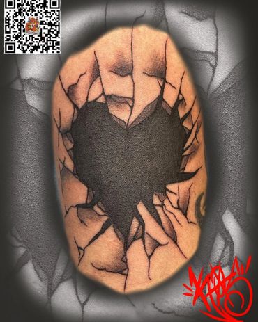 Tattoo of a shattered heart with cracked skin effect.