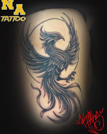 Black and gray phoenix tattoo with intricate feather details on skin.