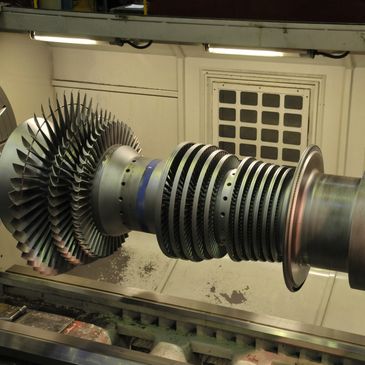 large turbine being machined in CNC lathe