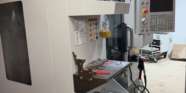 Industrial CNC machine setup in a workshop environment.