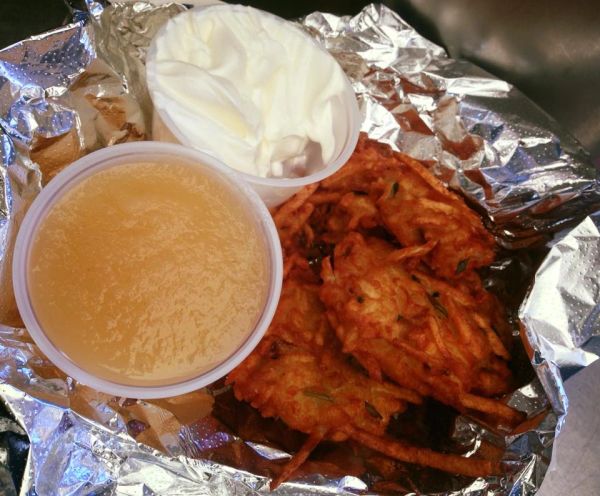 Fried latkes with applesauce and sour cream.