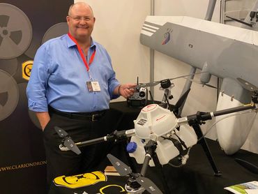 Patrick Fore showing a drone at a tradeshow