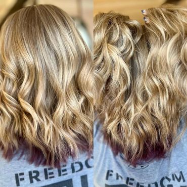 Blonde wavy hair with dark purple tips, styled beautifully.