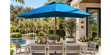 Outdoor dining area with blue umbrella and pool.