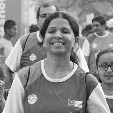 Happy participant runs at Run InSync, promoting health, unity, and community spirit.