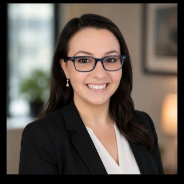 Professional woman with glasses smiling.