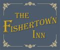 Elegant sign for The Fishertown Inn with gold lettering on a blue background.