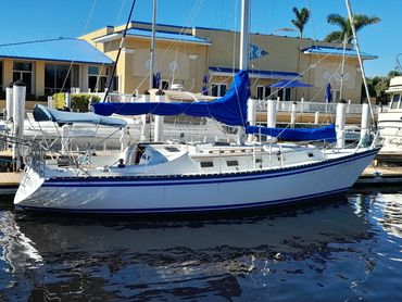 Side view of Courageous, a 37-foot Hunter Cherubini sailboat, docked in Port Charlotte, Florida.