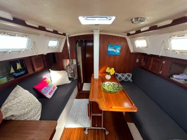 Close-up of cabin seating with cushions aboard the Courageous sailboat