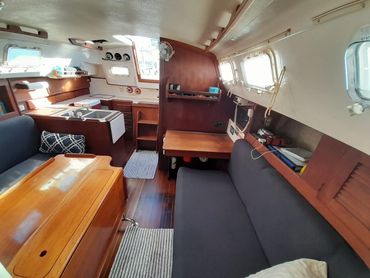 Interior cabin details of the Courageous sailboat, highlighting woodwork and amenities