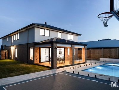 Rear view of new build. Covered alfresco, pool, basketball court and grassed area.