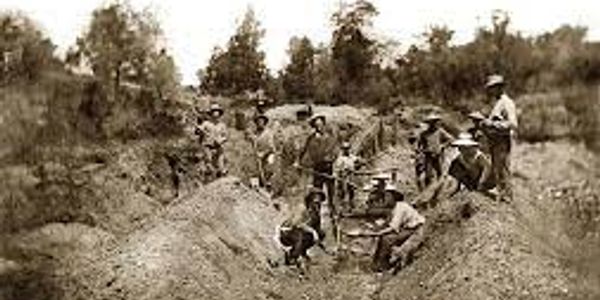 Group of people working in a trench, historical image.