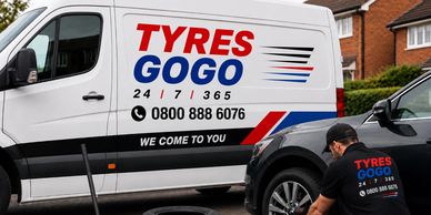 Mobile tyre fitting service with van and technician at work.