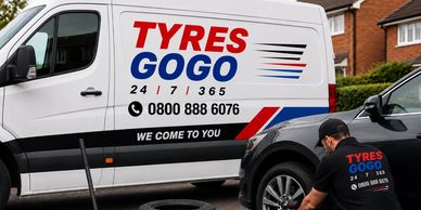 Mobile tyre fitting service with van and technician at work.