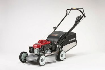 A Honda push lawn mower with a red engine and black grass catcher.