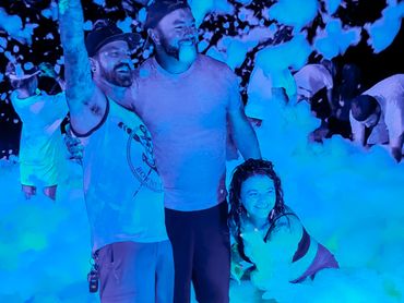 UV Glow Foam Party with adults having a fun celebration at night!
