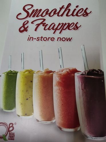 Colorful smoothies and frappes lineup with straws, promoting in-store availability.