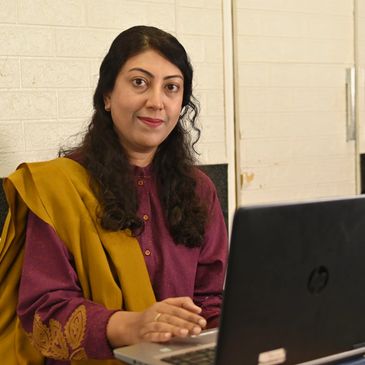 A woman smiling in a professional setting.