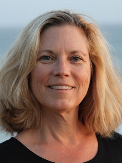 Portrait of a blonde woman with a gentle smile.