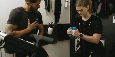 Personal training demonstrating correct breathing for Whole Body Electrical Muscle Stimulation trai