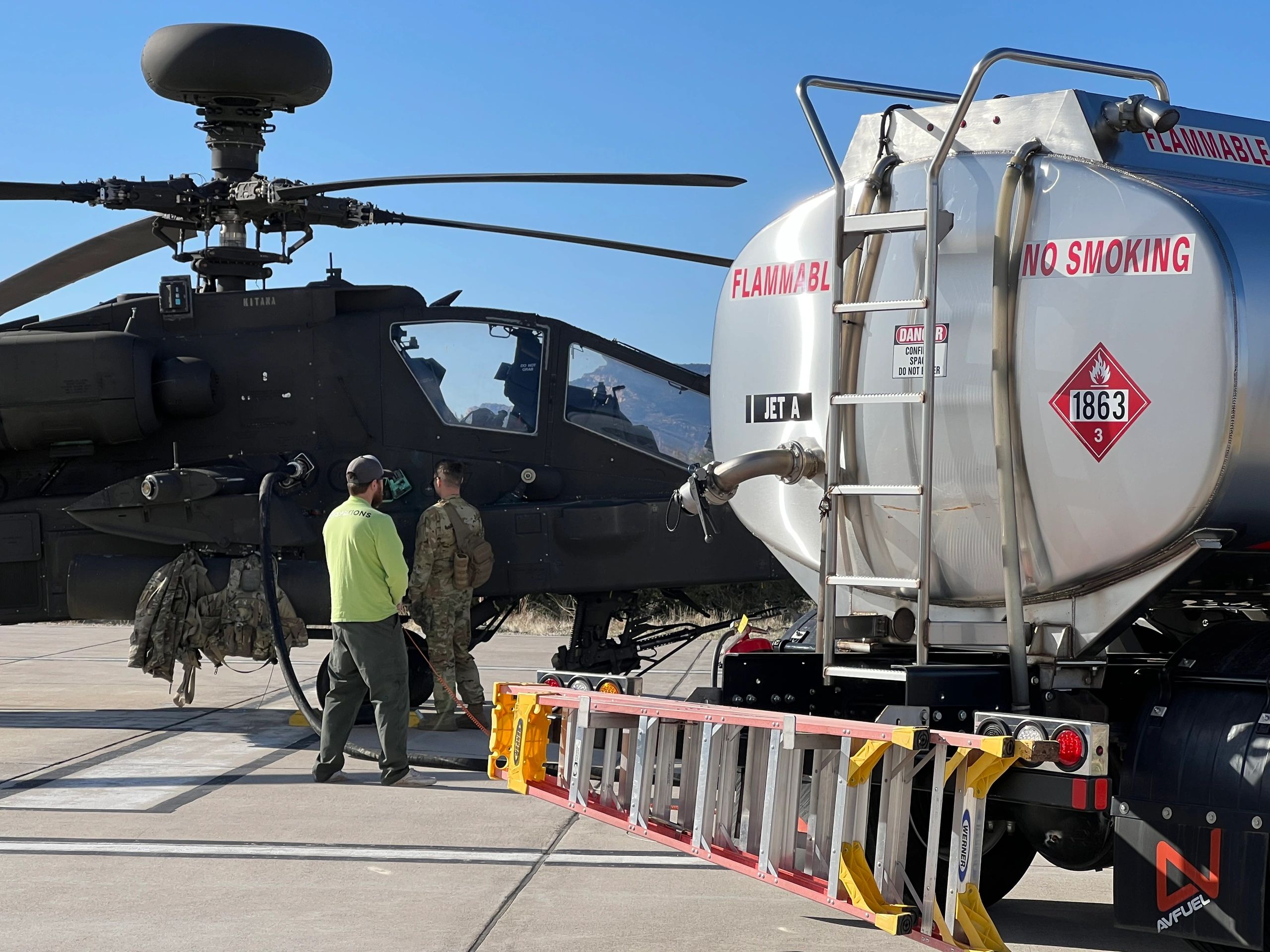 Line Technician fuels Apache Longbow helicopter using Single Point refueling.