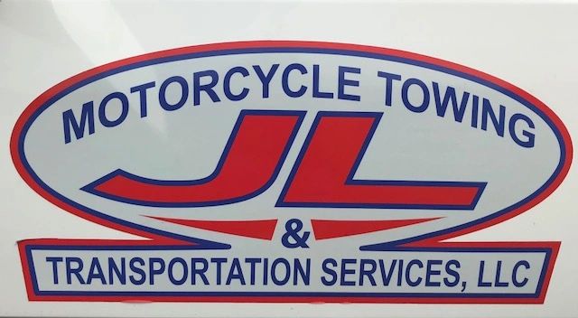 Close-up view of a speeding motorcycle on a road with motion blur.