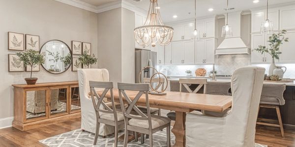 Elegant open-plan dining and kitchen area with modern lighting and wooden flooring.