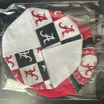 Face masks with Alabama Crimson Tide logos in a plastic bag.