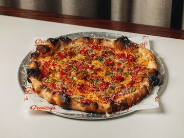 A crispy, thin-crust pizza with cheese and toppings.